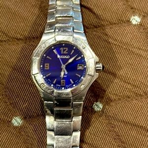 Seiko ladies stainless steel with blue face watch.